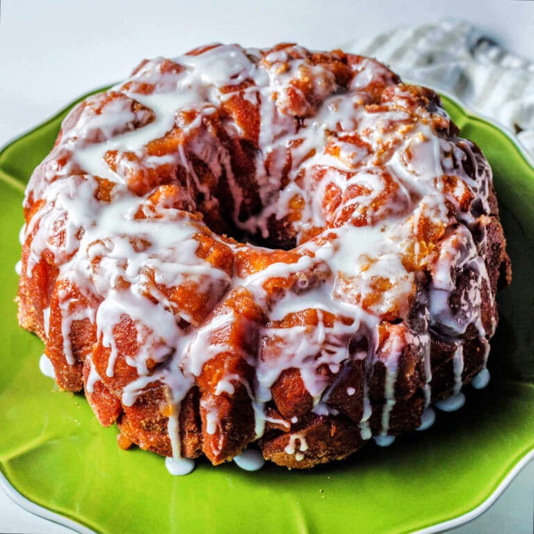 Glazed Monkey Bread on a scalloped plate.