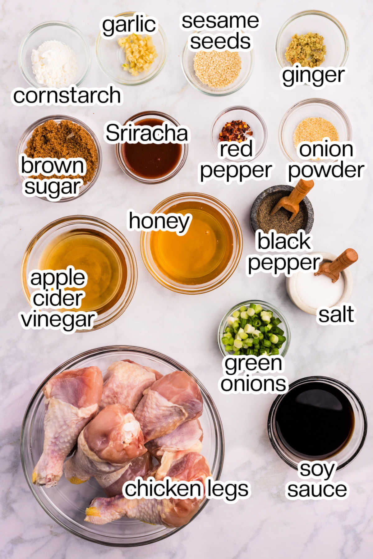 Ingredients for slow cooker chicken legs with sticky honey sauce on a table.