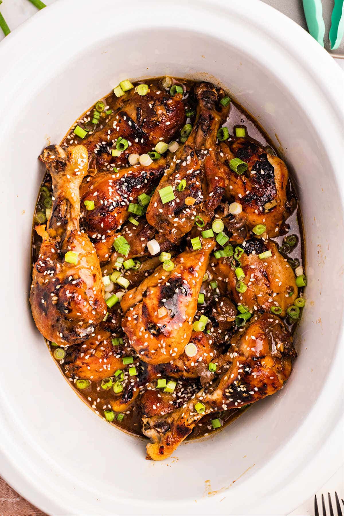 Chicken legs in a slow cooker with sticky honey sauce.