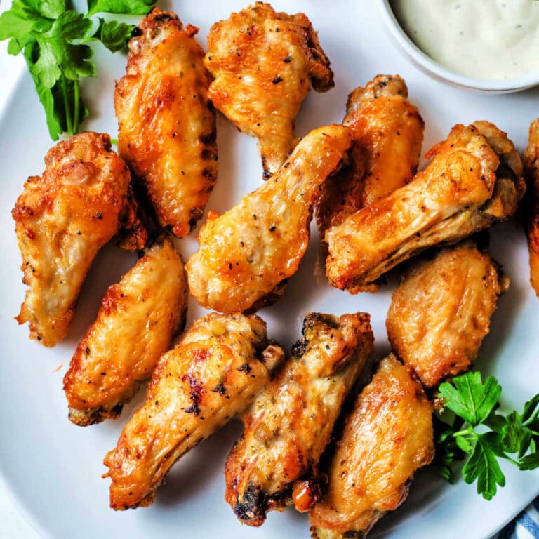 A platter of crispy Air Fryer Chicken Wings with a bowl of ranch dip to the side.