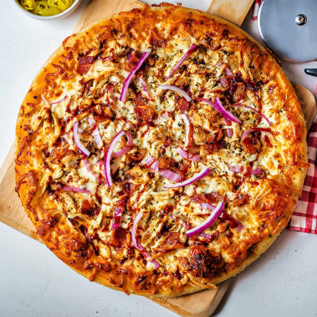 BBQ Chicken Pizza on a pizza peel.