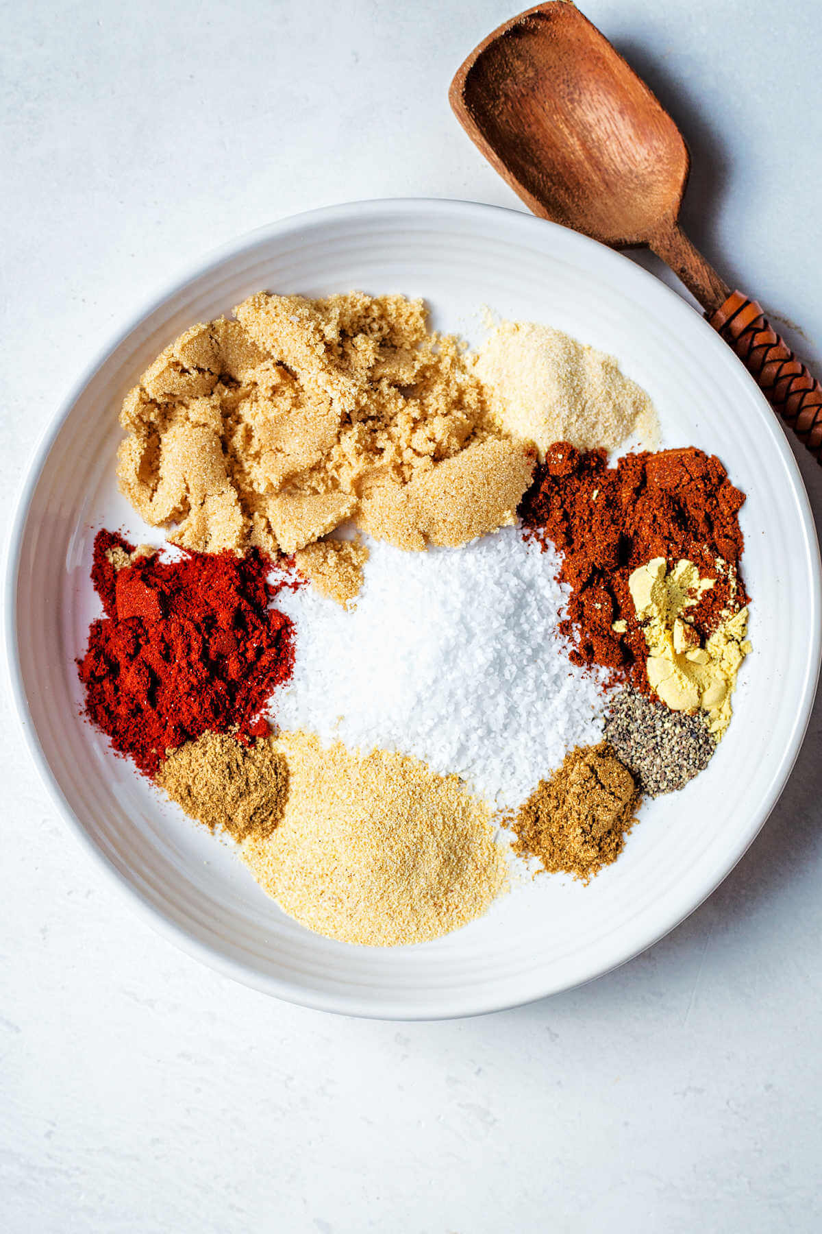 Ingredients for the pork dry rub measuring out into a bowl before being mixed together.