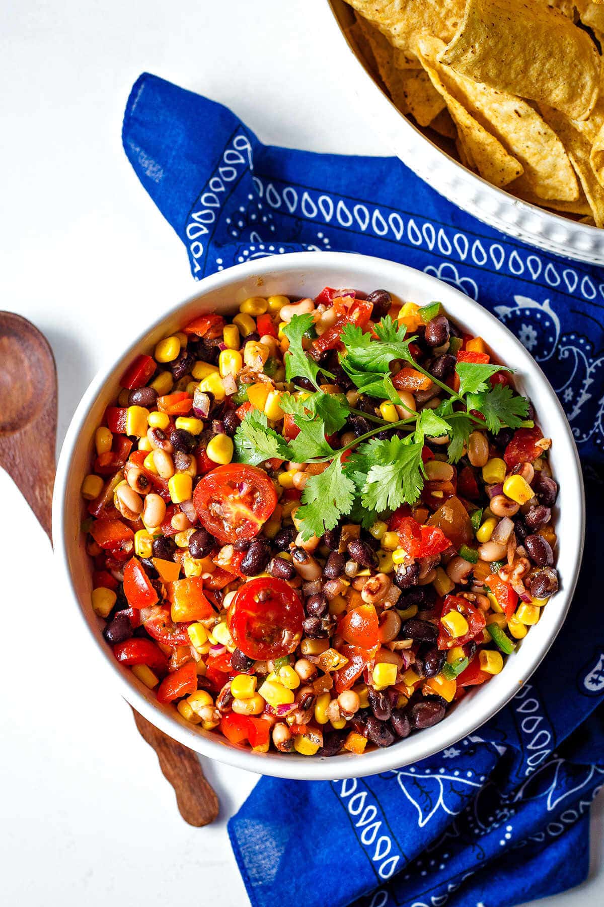 Overhead shot of finished cowboy caviar in a bowl garnished with cilantro.
