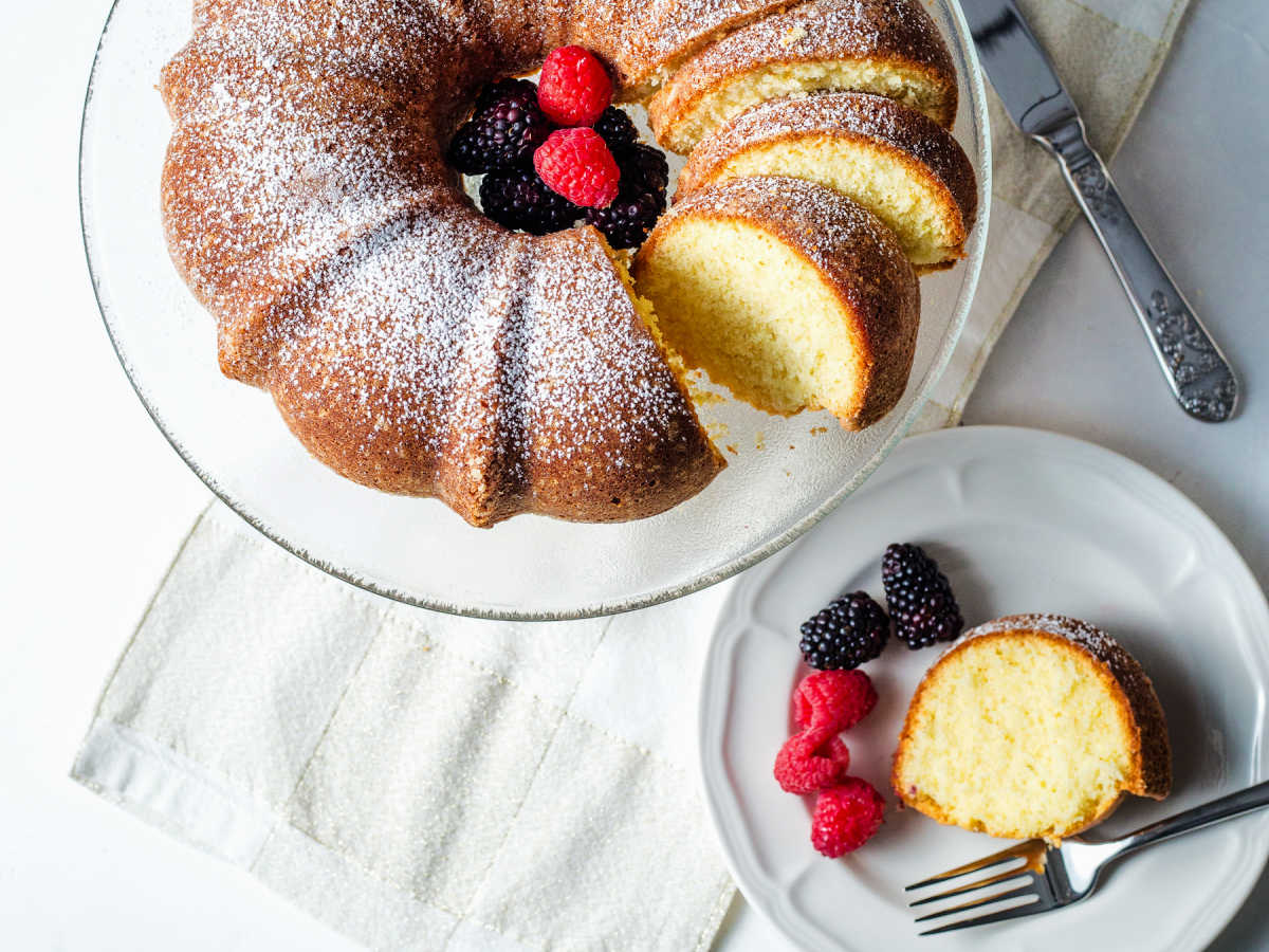Pound cake sliced on a plate with some of the cake sliced.