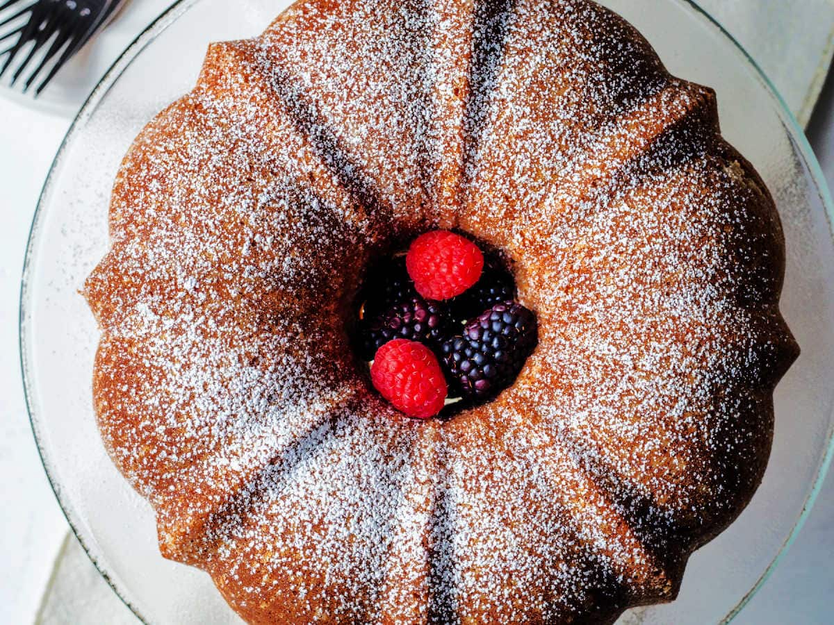 Overhead shot of pound cake served on a plate with powdered sugar on top.