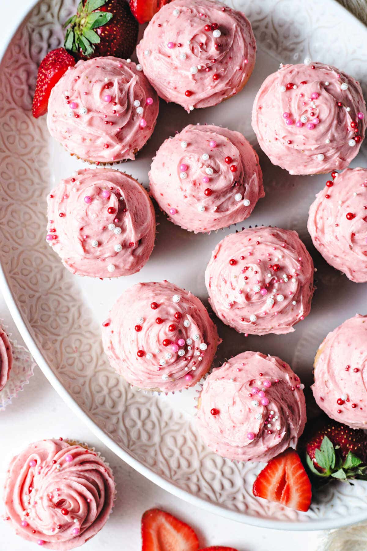 Overhead shot of strawberry cupcakes served on a serving dish.