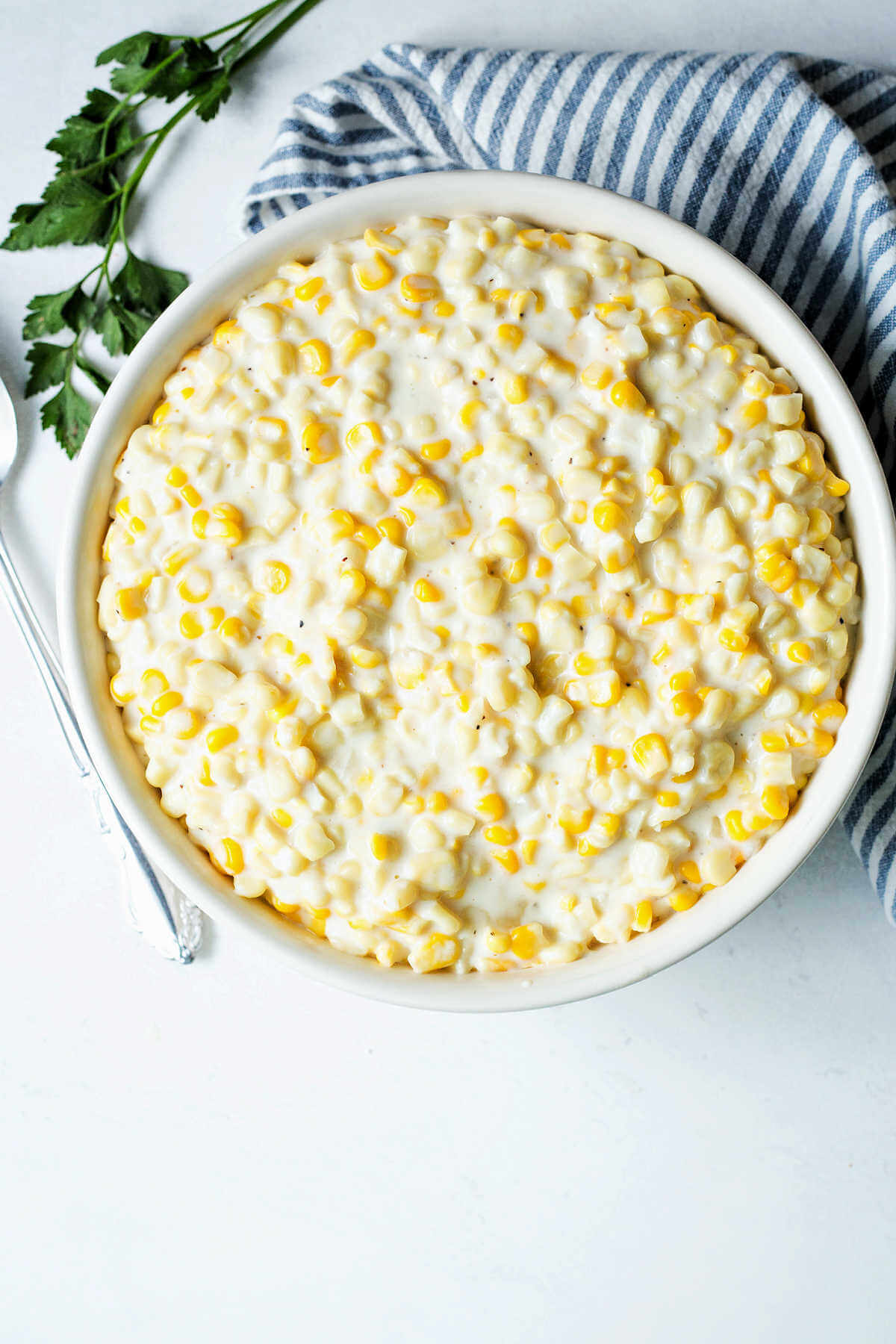 Creamed corn served in a large serving bowl.