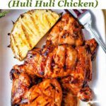 Serving platter of huli huli chicken thighs with grilled pineapple.