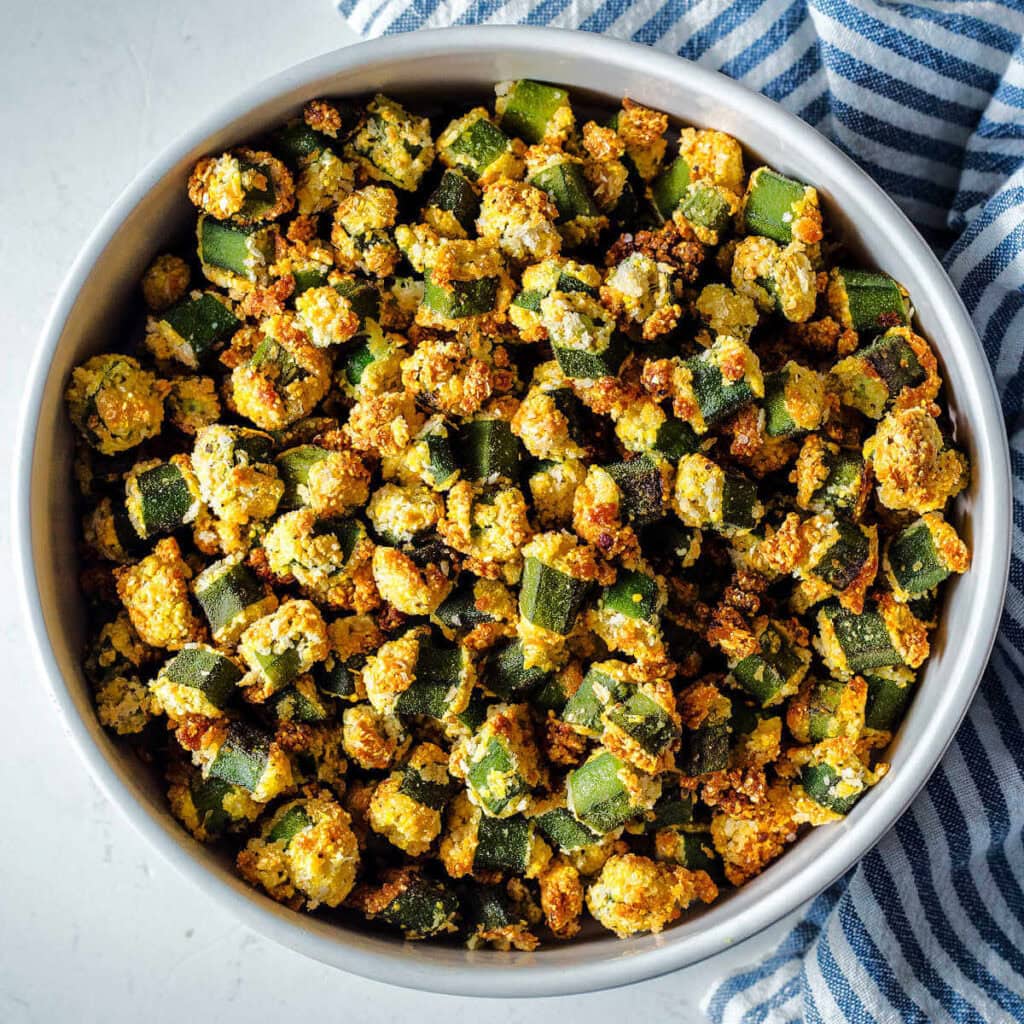 A bowl of oven-fried okra on a table.