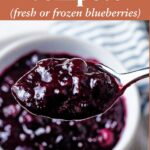 Blueberry Compote on a spoon with a text overlay.