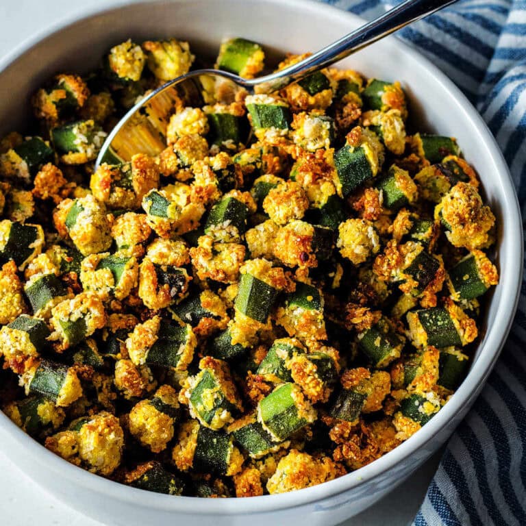 Oven-fried okra in a serving bowl with a spoon.