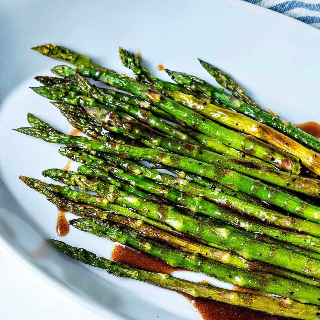 Roasted asparagus with brown butter in a serving dish.