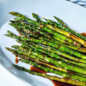 Roasted asparagus with brown butter in a serving dish.