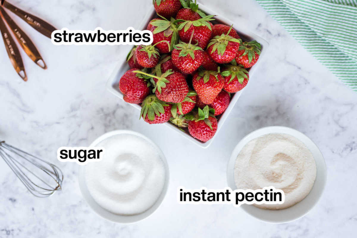 Ingredients for strawberry jam on a table.