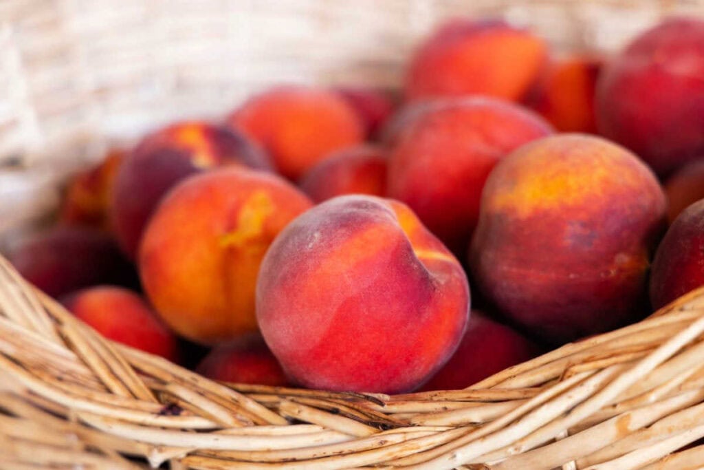 Fresh peaches in a basket.