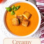 Single-image poster of creamy tomato soup in a rustic bowl topped with peppery Parmesan cornbread croutons, styled in warm terracotta, deep brown, olive green, and soft cream tones.